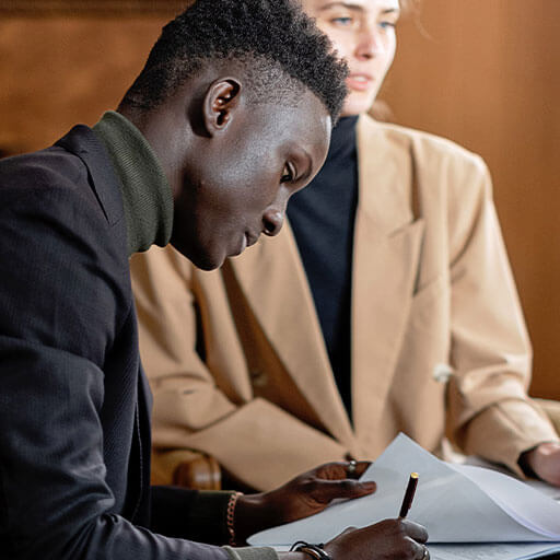 Client signing documents in boardroom